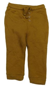 Bronzové tepláky s nášivkou KIABI