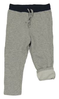 Sivé silnější tepláky s tmavomodrým pasom