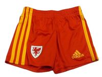 Červeno-oranžové športové kraťasy s logom Adidas