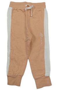 Broskvovo-bílé tepláky s nápisem