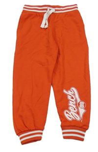 Červené tepláky s nápisem Bench