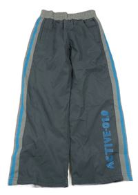 Tmavosivé šušťákové podšité nohavice s nápisom Topolino