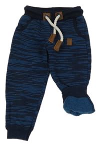 Tmavomodro-modré melírované tepláky s nášivkou 