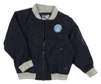 Tmavomodrá šušťáková zateplená bunda s nášivkou Mothercare