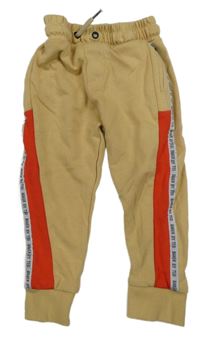 Béžovo-červené tepláky s nápisy Ted Baker