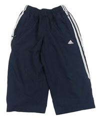 Tmavomodré šušťákové capri nohavice s logom Adidas