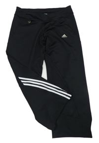 Černo-bílé sportovní crop tepláky s pruhy a logem Adidas