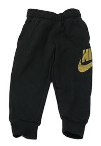 Černé tepláky se zlatým logem Nike