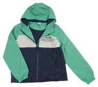 Mátovo-bílo-tmavomodrá šusťáková jarní bunda s nápisem a kapucí Y.F.K.