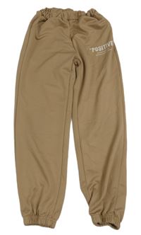 Béžové športové nohavice s nápisom