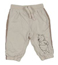 Bielo-béžové tepláky s Medvídkem Pú Disney