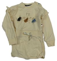 Smetanové teplákové šaty s nápisy a střapci a volánky Dirkje