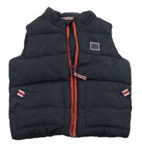 Tmavomodrá šušťáková prešívaná zateplená vesta Next