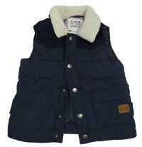 Tmavomodrá šušťáková zateplená vesta s huňatým golierom Matalan