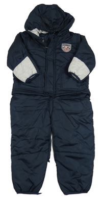 Tmavomodrá prošívaná šusťáková zimní kombinéza s nášivkou a kapucí impidimpi