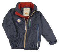 Tmavomodrá melírovaná šušťáková zateplená bunda s nášivkou a ukrývací kapucňou