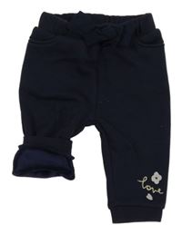 Tmavomodré zateplené tepláky s výšivkou a mašlí Orchestra