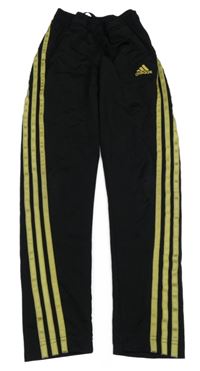 Černé sportovní funkční tepláky se zlatými pruhy a logem Adidas