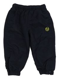 Tmavomodré šusťákové podšité kalhoty s výšivkou