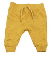 Okrové tepláky Primark