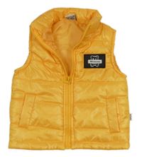 Pomerančová prešívaná šušťáková zateplená vesta s medvedíkom