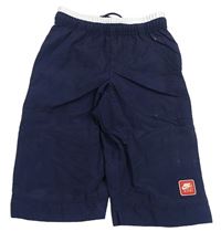 Tmavomodro-bílé šusťákové capri kalhoty s nášivkou Nike