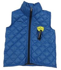 Modrá šušťáková prešívaná lehce zateplená vesta s nášivkou