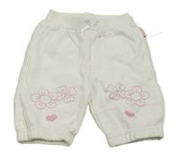 Bílé tepláky s výšivkami květů 