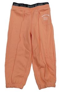 Korálové tepláky s nápisem River Island