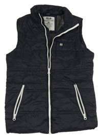 Tmavomodrá šušťáková zateplená vesta Staccato