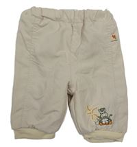 Béžové šušťákové zateplené nohavice s výšivkou