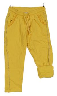 Hořčicové tepláky s volánky a třpytivým pruhem C&A