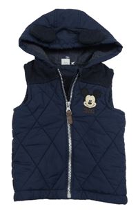 Tmavomodrá šusťáková prošívaná zateplená vesta s Mickeym a kapucí Disney