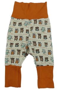 Bielo-oranžové tepláky so zvieratkami