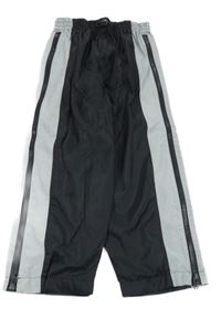 Čierno-sivé šušťákové nohavice so zipy