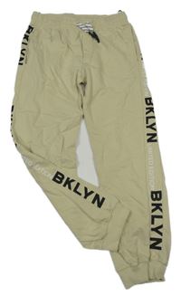 Béžové cuff tepláky s nápisy 