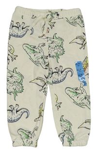 Nové - Smotanové tepláky s dinosaurami Primark