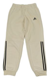 Smetanové tepláky s pruhy a logem Adidas