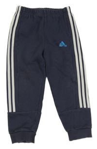 Tmavomodro-bílé tepláky s pruhy a logem Adidas