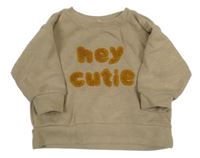 Béžový sveter s nápisom