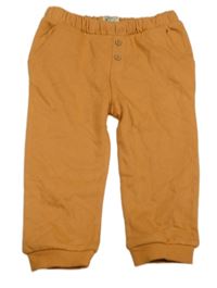 Oranžové tepláky s gombíkmi