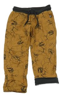 Hnedé vzorované plátenné podšité nohavice s lebkami dinosaurů a úpletovým pasom Dopodopo