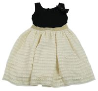 Černo-bílé šaty se vzorovanou sukní a zlatým pasem 