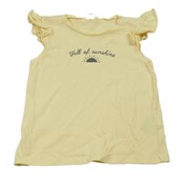 Svetložlté tričko s nápisom a slniečkom a volánikmi H&M