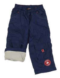 Tmavomodré šusťákové zateplené kalhoty s nášivkou 