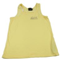 Žlutý sportovní top s nápisem a síťovinou Ergeenomixx