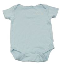 Světlemodré body s nápisem a smajlíkem Next