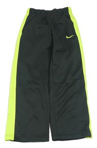 Tmavošedé sportovní tepláky se zeleným neonovým pruhem a logem Nike