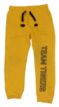 Žluté tepláky s nápisem H&M