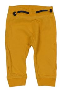 Horčicové tepláky s medvěďom Dopodopo